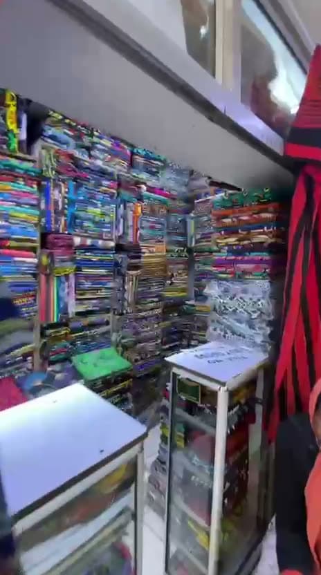 Inside and outside the Zion Vitenge Centre shop next to KCB Bank on River Road